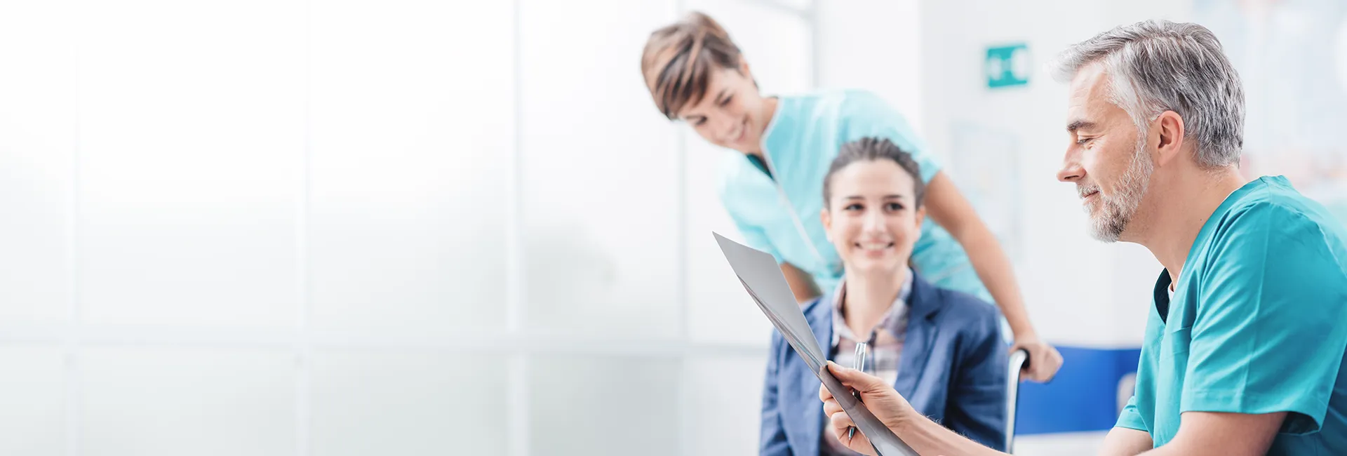 Arbeiten im RZ Alland: Arzt, Pflegerin, Patientin im Rollstuhl